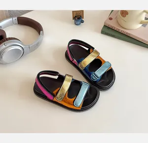 Detail of colorful metallic sandals with diamond stitching and triple hook-and-loop straps