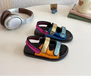 Detail showing colorful metallic leather straps and wave-patterned anti-slip soles of sandals