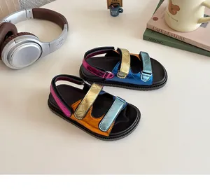 Close-up of kids' metallic sandals featuring quilted panels and triple velcro straps
