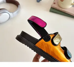 Macro detail of multi-color metallic leather sandals with diamond stitching and chunky sole