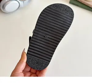 Close-up of flexible non-slip black sole for children sandals featuring size 28 marking