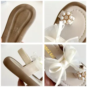 Girls cream sandals with organza bow and pearls, featuring non-slip rubber soles