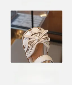 Detail shot of girls' bow princess sandal showing lace mesh and round toe design