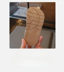 Detail of children's sandals brown non-slip outsole with wave texture and size 23 mark