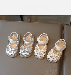 Detailed top view of kids closed-toe sandals with lace mesh bows and velcro straps