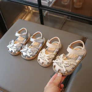 Kids bow-knot closed-toe princess sandals in silver and cream for summer 2025