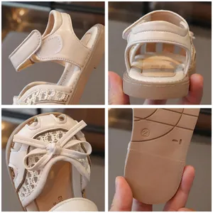 Beige girl's closed-toe princess sandals with lace mesh and cute bow details
