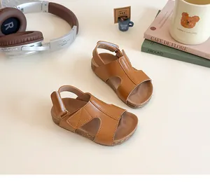 Kids brown cork footbed sandals with velcro straps in a cozy lifestyle setting