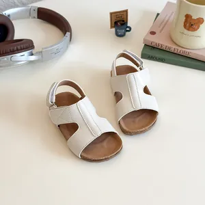 White children's Birkenstock style sandals with cork sole and non-slip rubber outsole