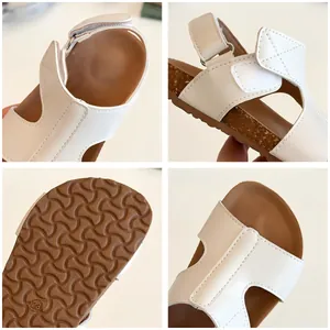 White children's sandals with adjustable velcro straps and non-slip brown cork soles