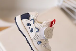 Detail view of breathable mesh fabric and cartoon panda design on toddler walking shoes