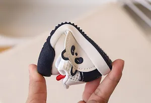 Detail showing the flexible soft sole of the panda baby walking shoes being bent easily