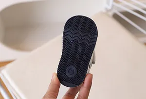 Close-up of flexible rubber sole with wavy anti-slip texture on infant sneakers