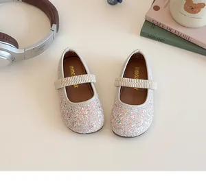 Overhead view of silver sequin Mary Jane flats for girls with elastic strap and cute props