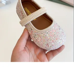 Detailed close-up of sparkling multicolor sequins and elastic strap on girls Mary Jane shoes