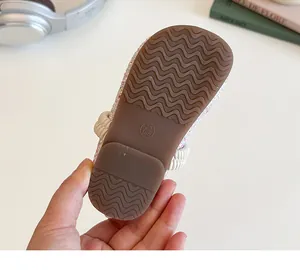 Macro shot of a flexible translucent brown rubber sole with non-slip wave patterns for kids
