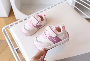 Dettaglio scarpe bimbo rosa e bianco con chiusura a strappo e fori traspiranti