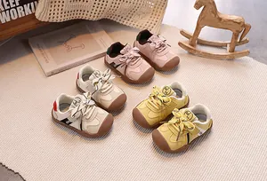 Toddler walking shoes detail showing leather and fabric mix with hook and loop closure