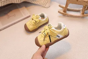 Detail of yellow toddler sneaker featuring non-slip rubber sole and velcro closure