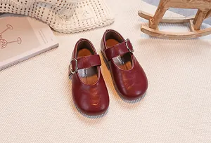 Detail view of burgundy girls' Mary Jane shoes with adjustable buckle and matte finish