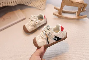 Detailed close-up of soft-sole baby sneaker with non-slip rubber bottom and leather upper