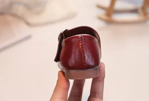 Close-up of deep red Mary Jane leather shoes for girls with anti-slip rubber soles