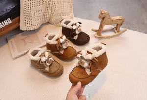 Detail of warm winter baby boots with rabbit ears decoration and thick fleece lining