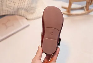 Detailed macro view of non-slip rubber sole with texture on girls brown leather shoes