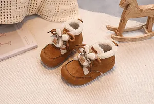 Close-up of cozy brown baby winter boots with warm plush lining and handmade details