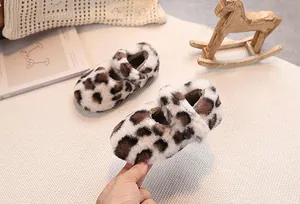 Close-up of leopard print plush baby shoes with soft faux fur texture and secure straps
