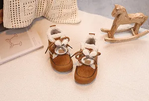 Close-up of cute rabbit winter boots for baby girls with warm fur lining and handmade label