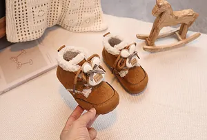 Close-up of winter baby boots with cute rabbit ears, plush lining and bow detail