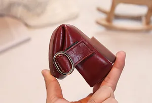 Close-up of flexible non-slip rubber sole on a burgundy leather girls flat shoe