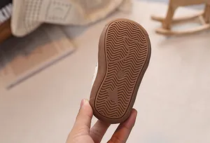 Detail of baby shoe rubber sole with anti-slip wave pattern and star design element