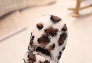 Detailed macro view of plush leopard print faux fur texture on children's winter shoes