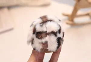 Macro detail of baby plush leopard print shoes with soft faux fur and non-slip sole