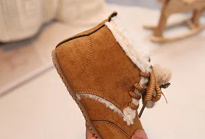 Detail of warm brown suede baby boots with thick plush lining and woven laces