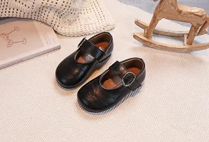 Detailed top view of classic black Mary Jane shoes for girls with elegant silver buckle