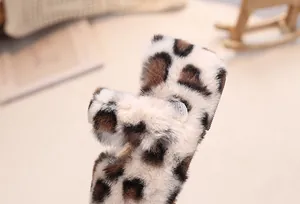 Macro view of plush leopard print texture on warm faux fur material for children shoes