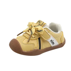 Yellow toddler leather sneakers with non-slip rubber soles and velcro straps for baby boys