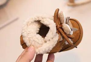 Close-up of baby winter snow boots featuring warm lamb wool lining and suede fabric
