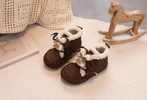 Detail of warm brown suede baby snow boots with cute rabbit ears and plush lining