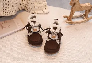 Detail of warm baby winter boots in brown suede with plush lining and cute bunny ears