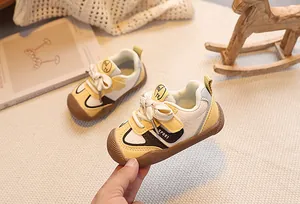 Detailed side view of toddler sport shoes with brown rubber toe cap and sport patch