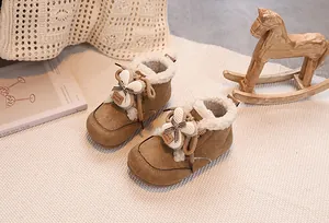 Close-up of winter baby boots with rabbit ears, plush lining and suede texture
