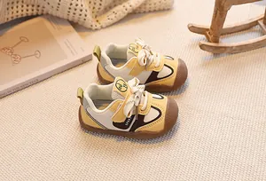 Close-up of toddler sport shoes featuring multi-color patchwork and wide anti-collision toes