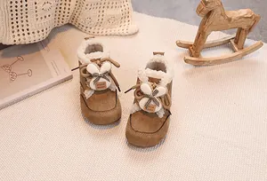 Detail of warm brown suede toddler boots featuring plush lining and 3D bunny ear accents