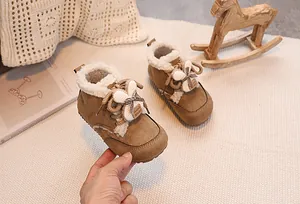 Detail of warm brown suede baby boots with rabbit ears and plush fleece lining