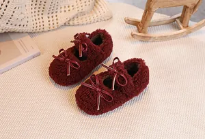Detail of plush burgundy Mary Jane shoes for girls with fluffy texture and ribbon bow