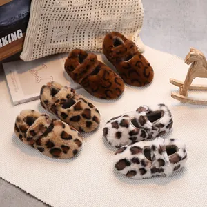 Three pairs of leopard print plush baby winter walking shoes on a soft knit rug